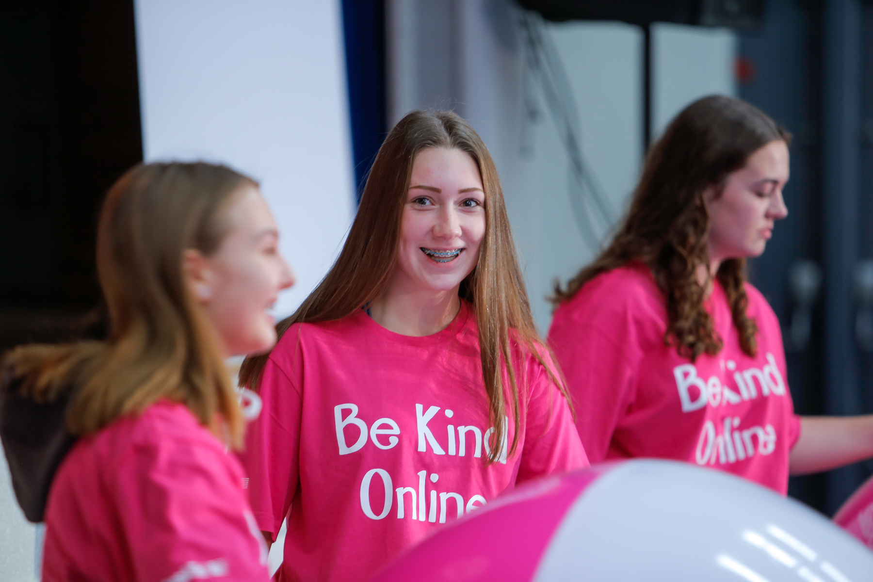 Smiling girl with Be Kind Online t-shirt