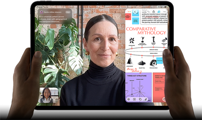 iPad Pro, front exterior, landscape orientation, space black colour, rounded corners, black display bezel, hands holding left and right sides, display showing a FaceTime conversation being live translated, and an educational app showing a presentation of "Comparative Mythology" with text, diagrams and handwritten notes