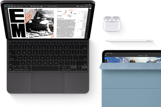 iPad Pro attached to Magic Keyboard, front exterior, space black colour, rounded corners, black display bezel, open, display showing article editing app with text and photograph of a woman playing music, Airpods 4 in open case, blue Smart Folio cover on iPad Pro with Apple Pencil Pro resting atop device, cover slightly open revealing display