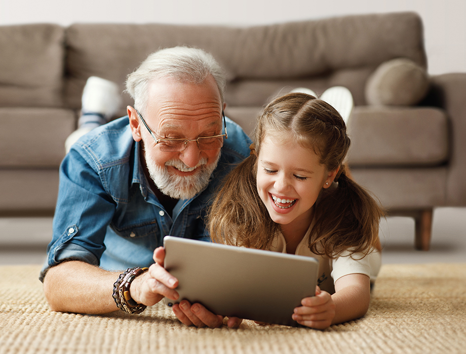 A Grandpa and Grandchild watching maxTV Stream on a tablet