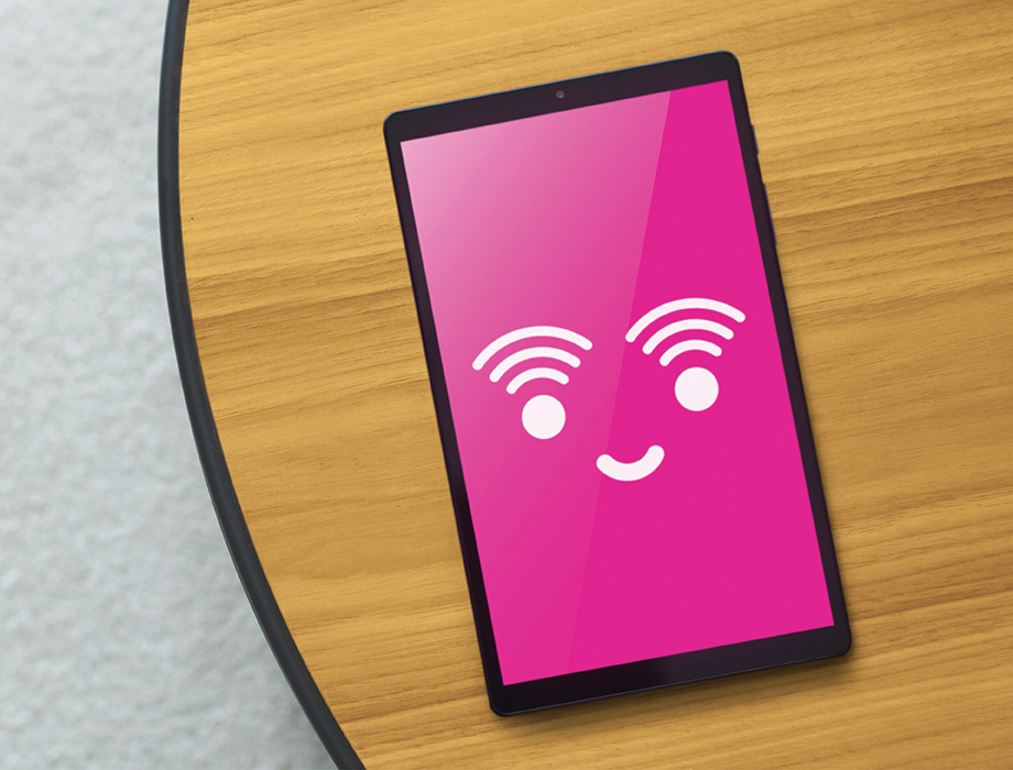 tablet with a white smiley face on a pink background.