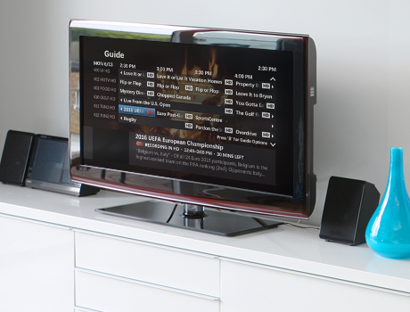 a TV showing the maxTV on-screen guide