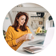 Woman working from home looking at laptop