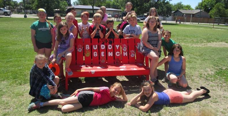 RAK Pack members with buddy bench