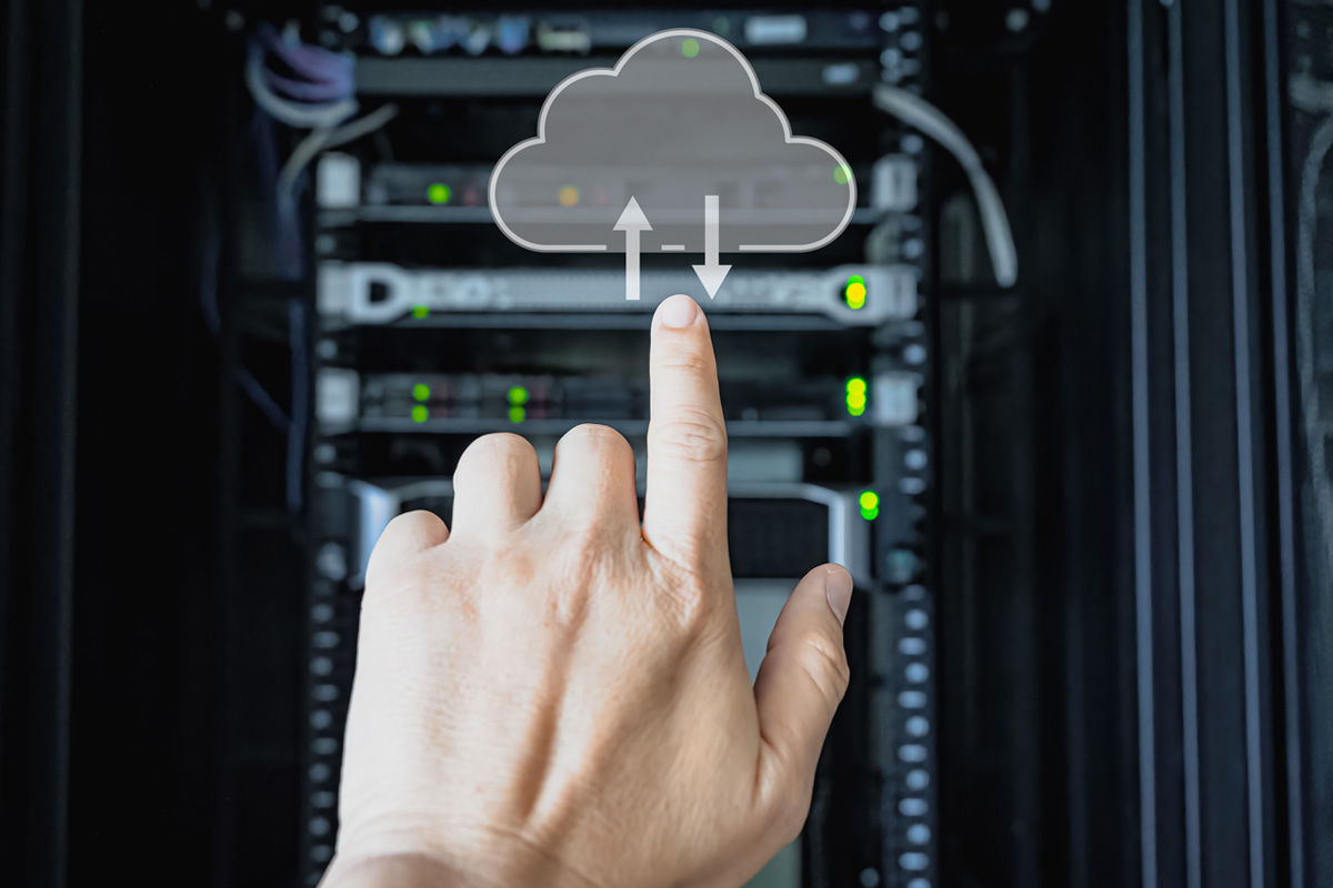 hand pointing at server rack with cloud graphic