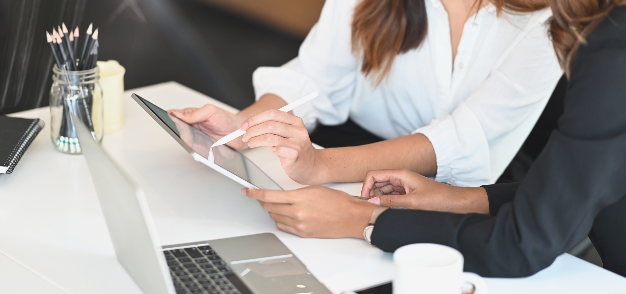 Employee and client working together on smart tablet