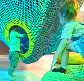 a kid playing in a display at the Nutrien Wonderhub