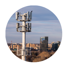 Cellular tower backed by city skyline
