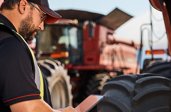 Man in field by tractor