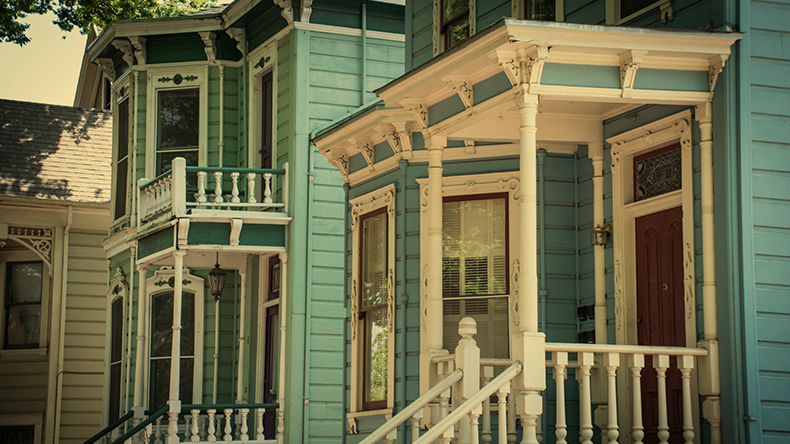 an old house in Sacramento with ornate wooden window frames and bannisters an old house in Sacramento with ornate wooden window frames and bannisters